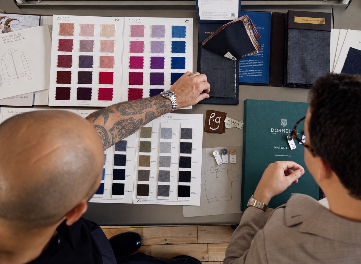 Hands reviewing fabric swatches during a private consultation
