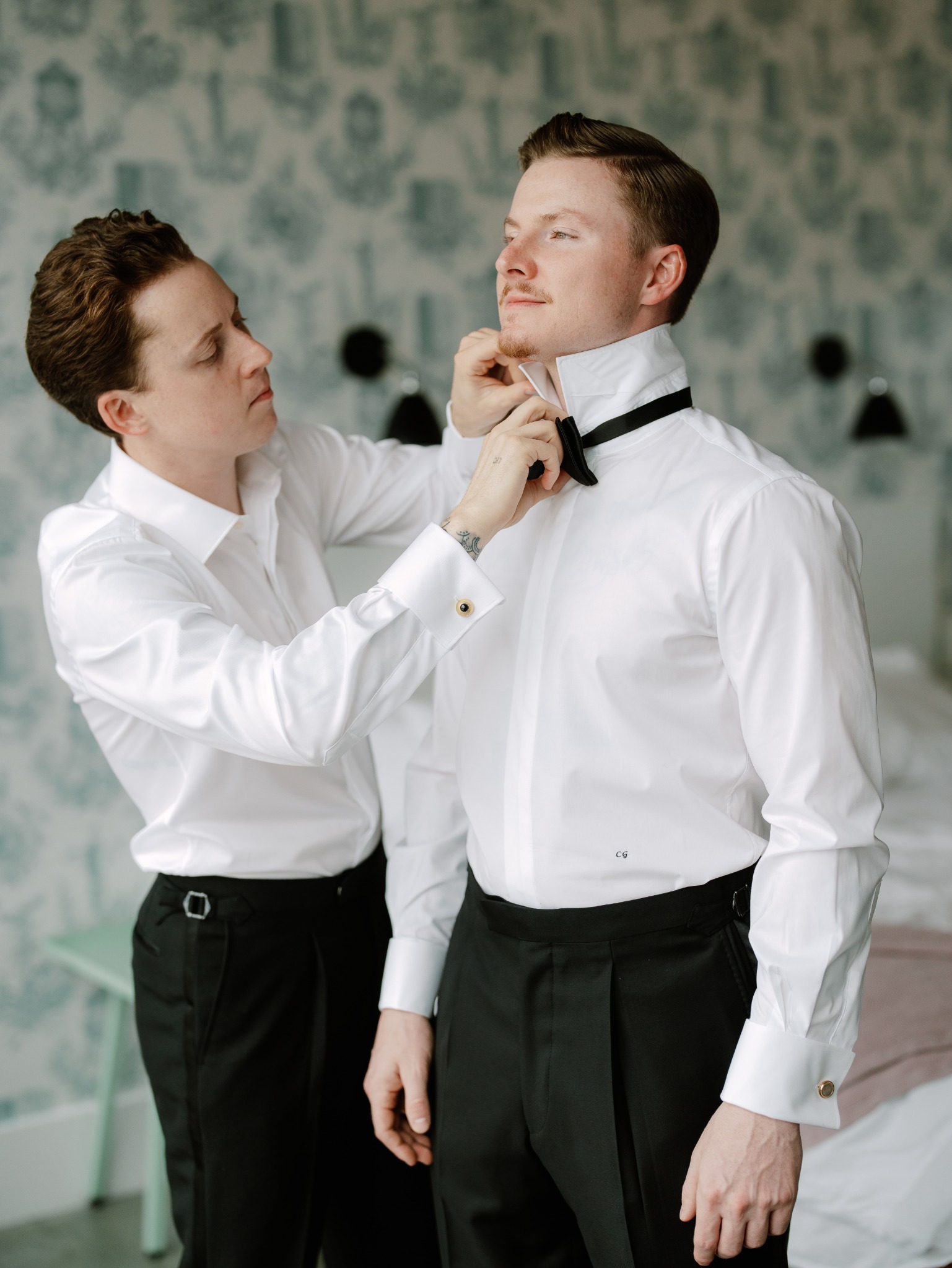 Hands adjusting a bow tie