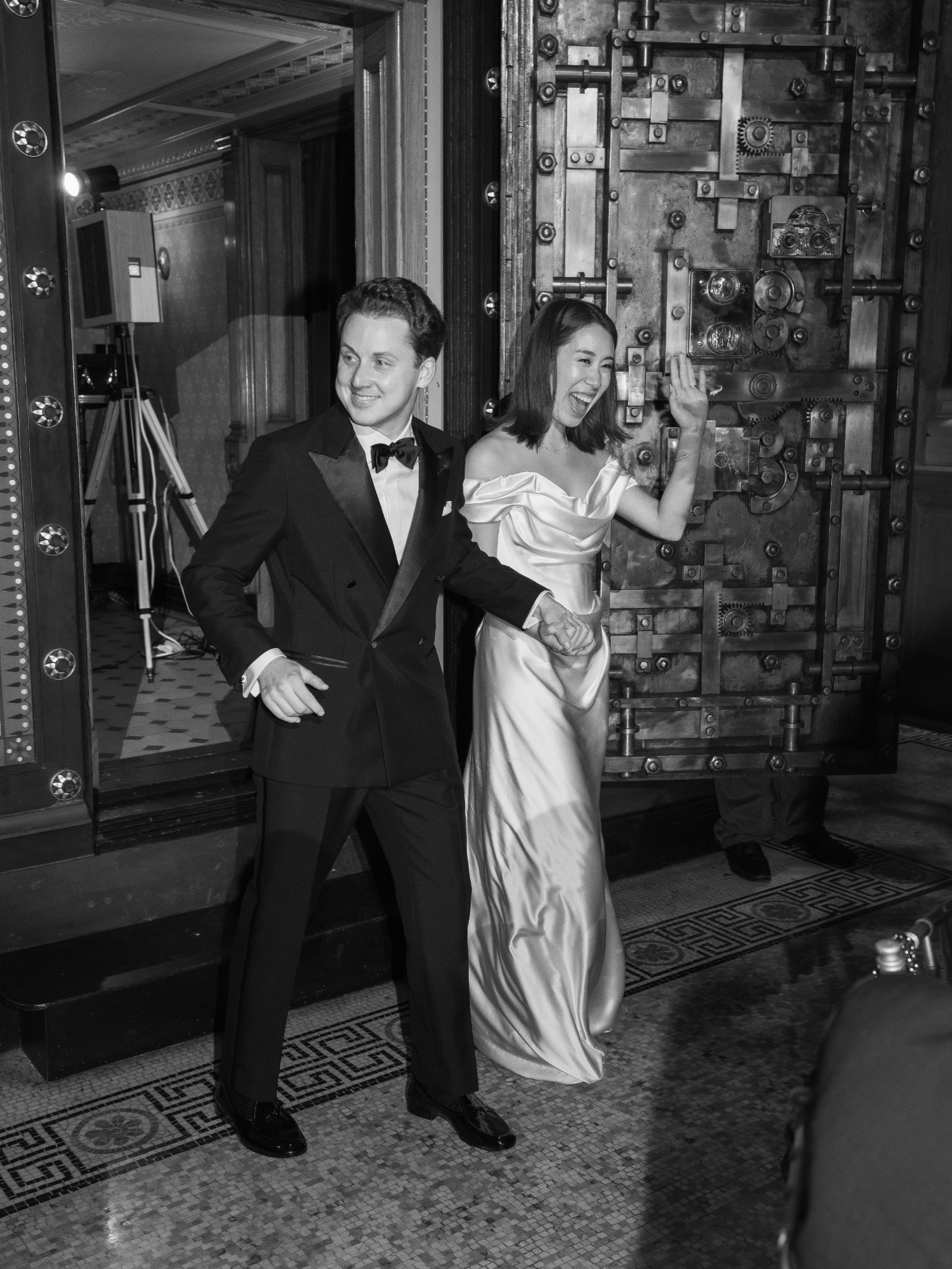Tuxedo in motion against a historic vault doorway