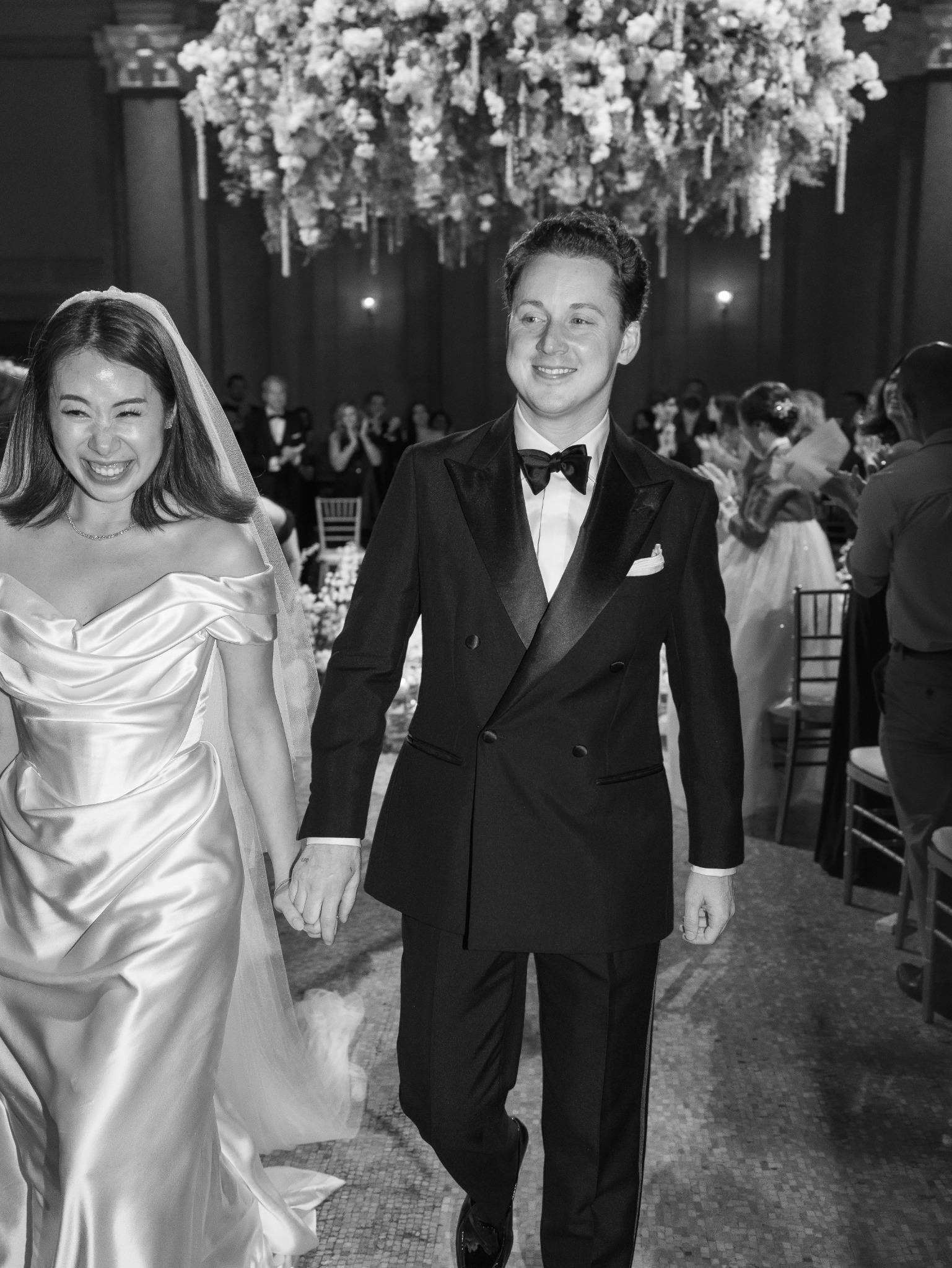 Entering an evening reception in a bespoke tuxedo