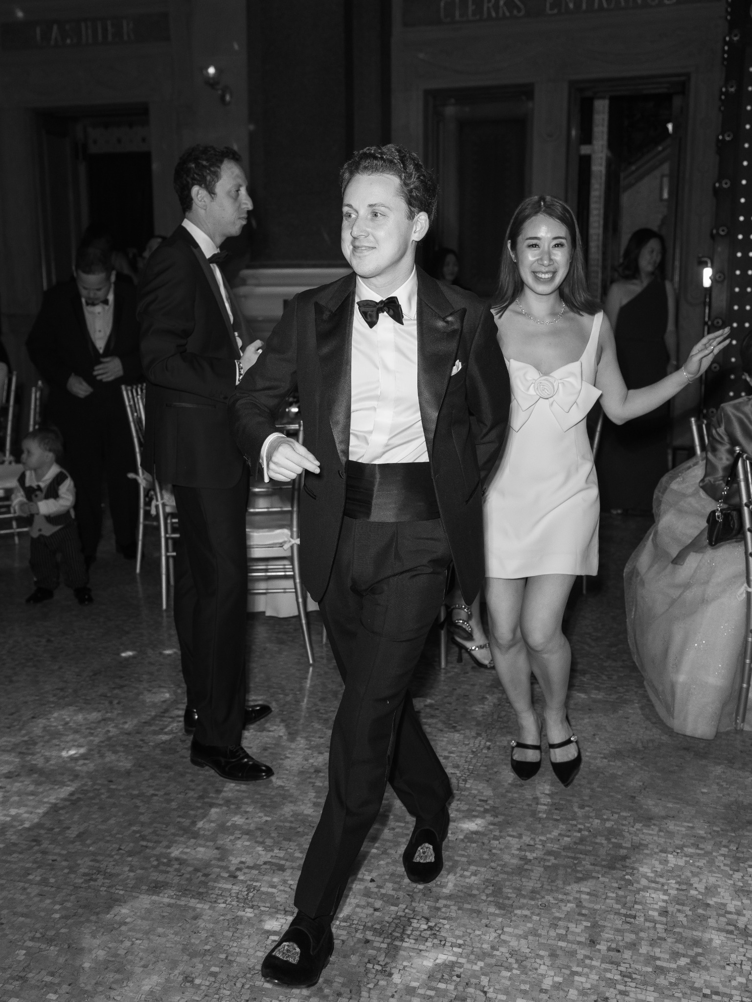 Tuxedo silhouette moving through an evening reception
