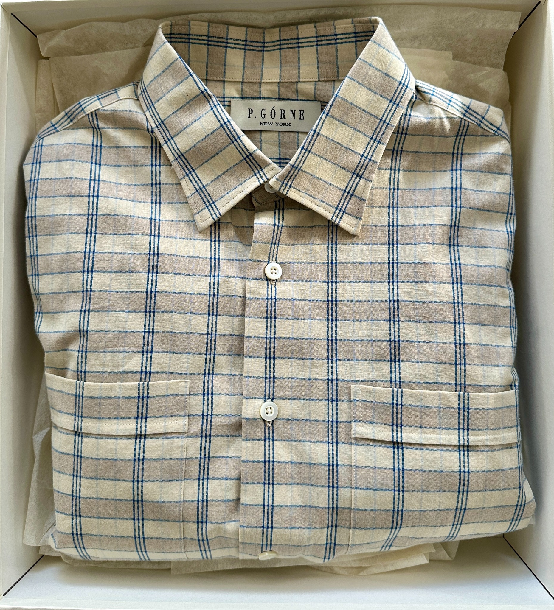 Light blue knit polo displayed in the atelier